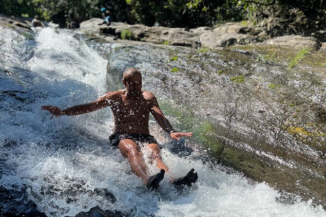 El Yunque Waterslide and Waterfall Tour with Food and Photos - Stop 1 in El Yunque: rockslides, waterfall swimming, and real footing