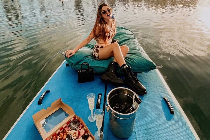 San Juan — Private Floating Picnic Experience in Condado Lagoon - Boarding the floating picnic raft: rose petals, pillows, shade